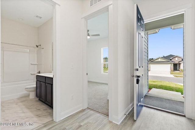 entryway with ceiling fan and light hardwood / wood-style flooring