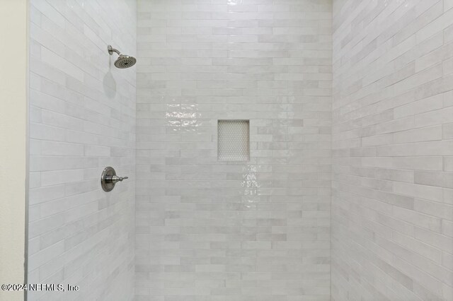 bathroom with a tile shower