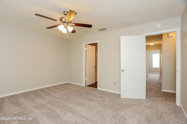 12229 Mastin Cove Rd, Jacksonville, FL 32225 - unfurnished bedroom featuring carpet floors, a textured ceiling, baseboards, and a ceiling fan