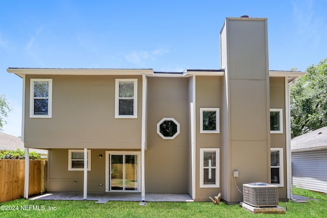 back of house featuring cooling unit, a yard, and a patio area