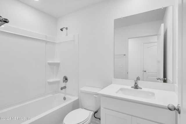 full bathroom featuring vanity, washtub / shower combination, and toilet