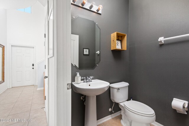 bathroom with toilet and tile patterned flooring