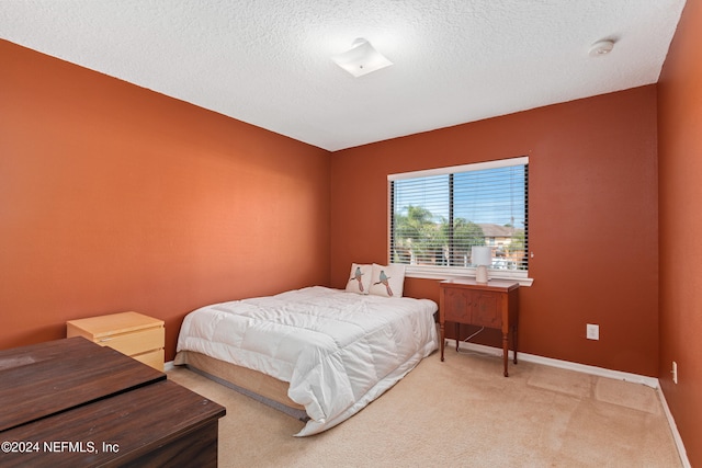 carpeted bedroom featuring a textured ceiling