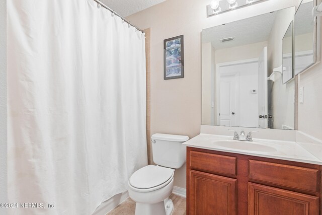 bathroom with vanity, a textured ceiling, toilet, and a shower with shower curtain