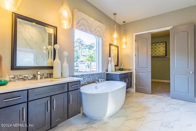 bathroom featuring a bathtub, vanity, and decorative backsplash