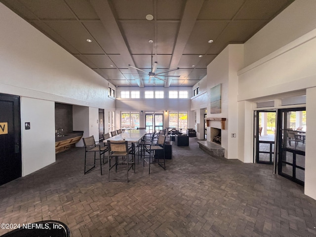 dining room with a towering ceiling and ceiling fan