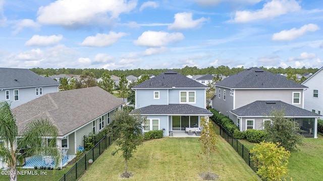 rear view of property featuring a yard