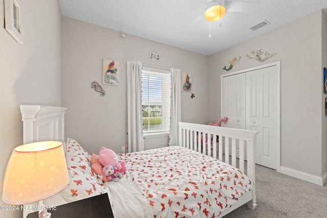 carpeted bedroom featuring ceiling fan and a closet