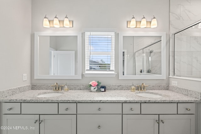 bathroom with vanity and a shower with shower door