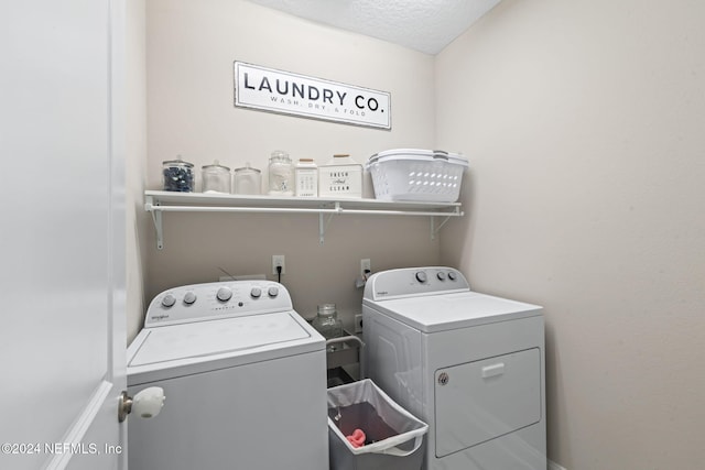 laundry room featuring sink, a textured ceiling, and separate washer and dryer