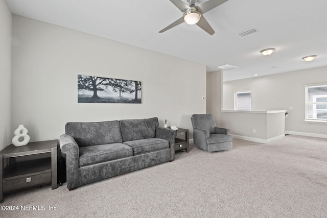 carpeted living room with ceiling fan