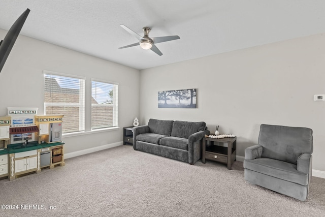 carpeted living room featuring ceiling fan