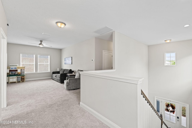 hallway featuring light colored carpet