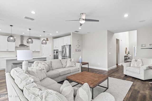 living room with dark hardwood / wood-style flooring and ceiling fan