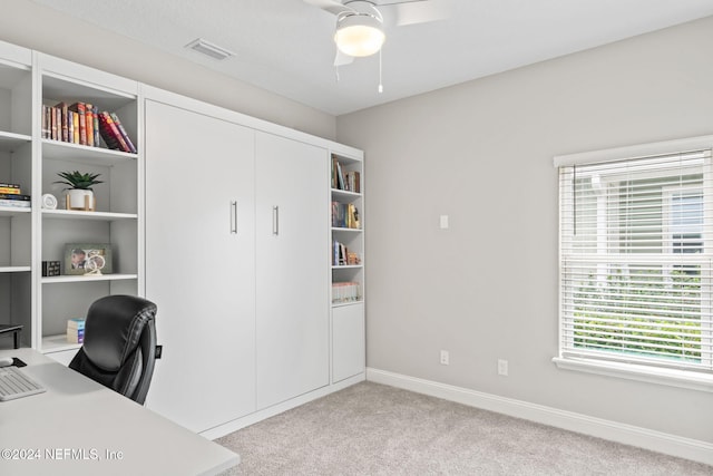 carpeted office space with ceiling fan