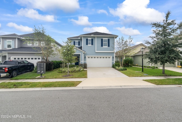 view of property with a garage and a front lawn