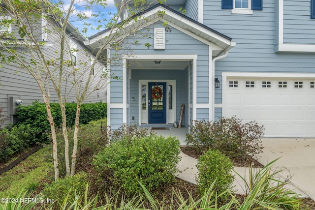 view of exterior entry featuring a garage