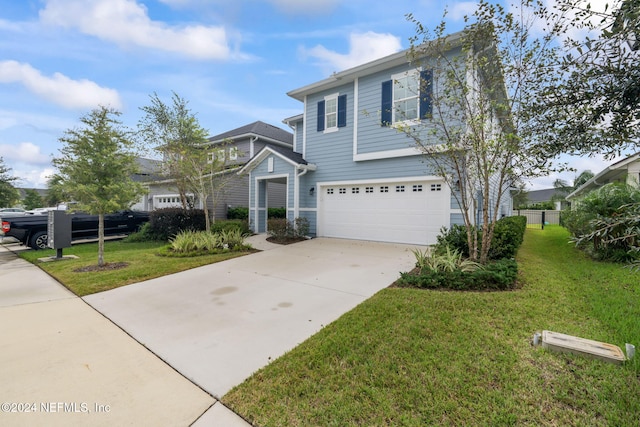 view of front of property featuring a garage and a front yard