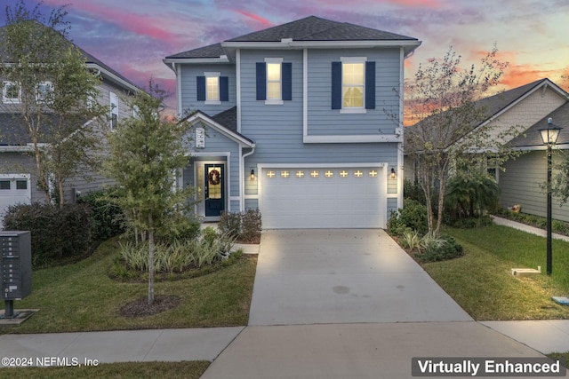 view of front of home featuring a garage and a yard