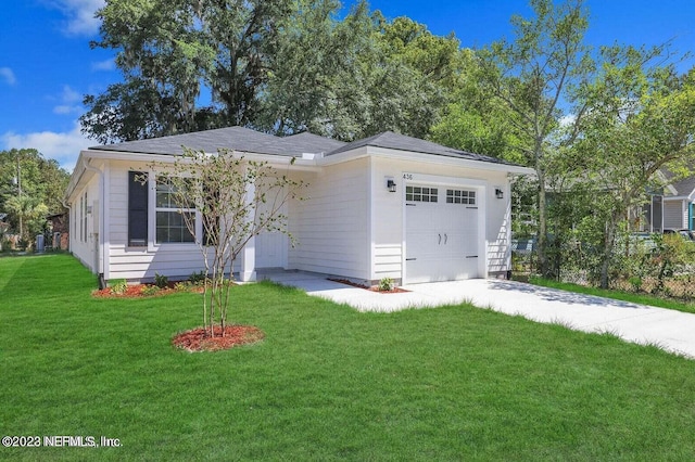 single story home featuring a garage and a front yard