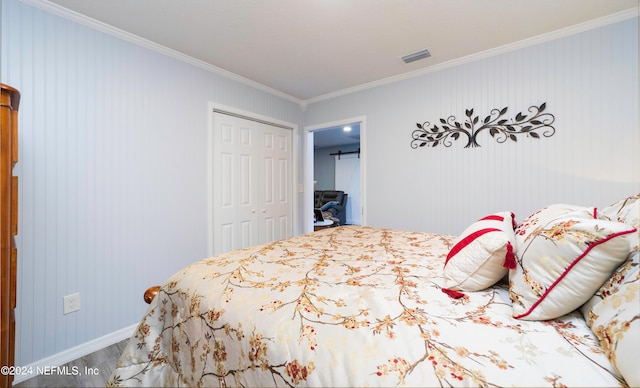 bedroom featuring a closet and crown molding