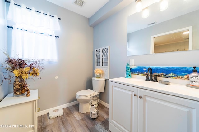 bathroom featuring hardwood / wood-style floors, vanity, and toilet