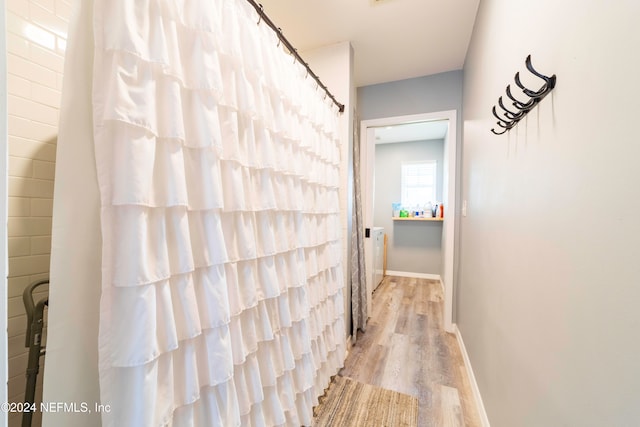 hallway with light hardwood / wood-style floors