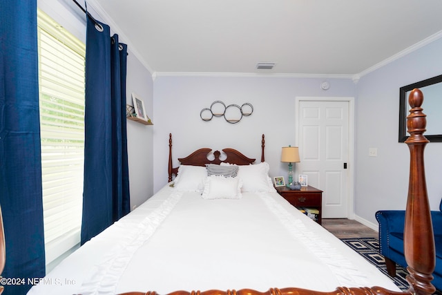 bedroom with hardwood / wood-style flooring and crown molding