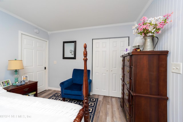 bedroom featuring ornamental molding, hardwood / wood-style floors, and a closet