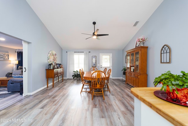 dining area featuring high vaulted ceiling, ceiling fan, and light hardwood / wood-style floors