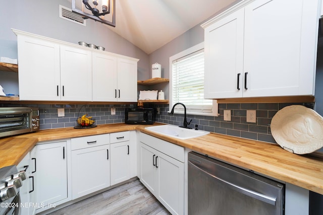 kitchen featuring white cabinets and butcher block countertops