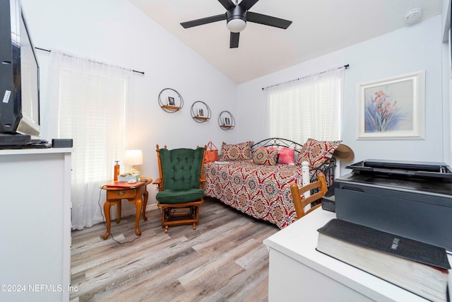 bedroom featuring ceiling fan, lofted ceiling, and light hardwood / wood-style floors