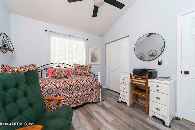 bedroom featuring a closet, lofted ceiling, ceiling fan, and light hardwood / wood-style flooring