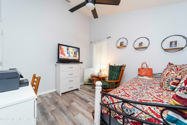 bedroom with high vaulted ceiling, ceiling fan, and light hardwood / wood-style flooring