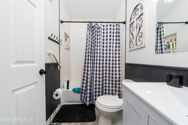 full bathroom featuring toilet, vanity, wood-type flooring, and shower / bathtub combination with curtain