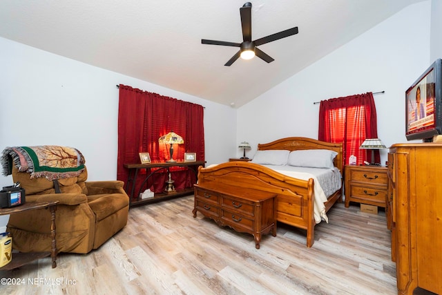 bedroom with light hardwood / wood-style flooring, lofted ceiling, and ceiling fan