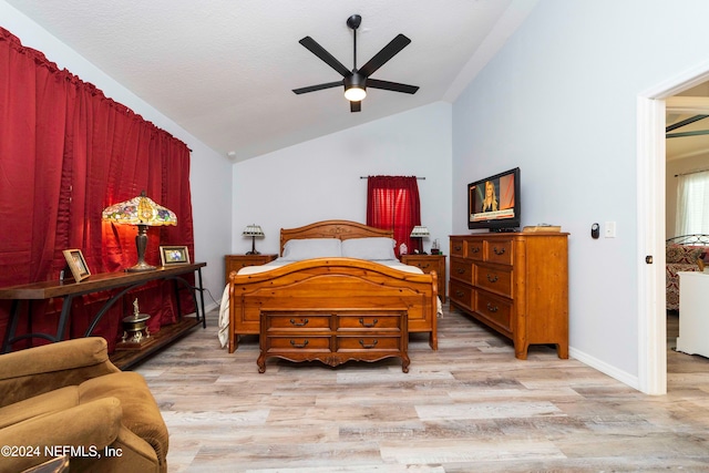 bedroom featuring light hardwood / wood-style floors, ceiling fan, and lofted ceiling