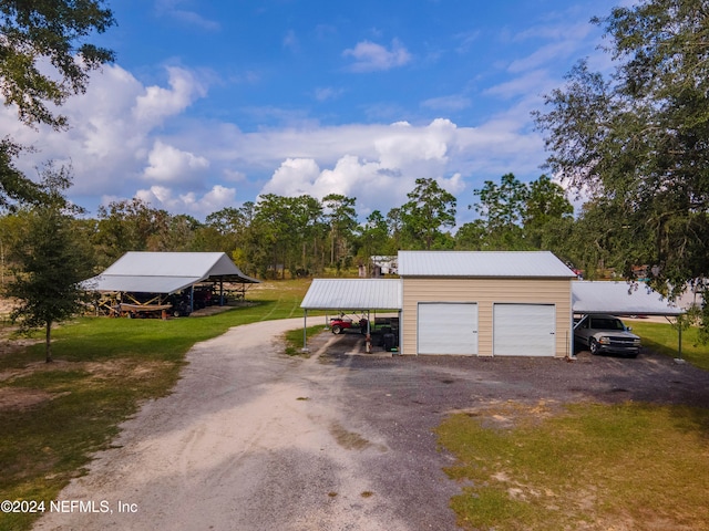 garage featuring a lawn and a carport