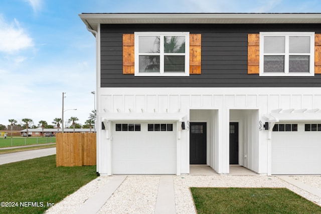 view of front of home with a front lawn and a garage