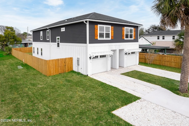 exterior space with a garage and a front lawn