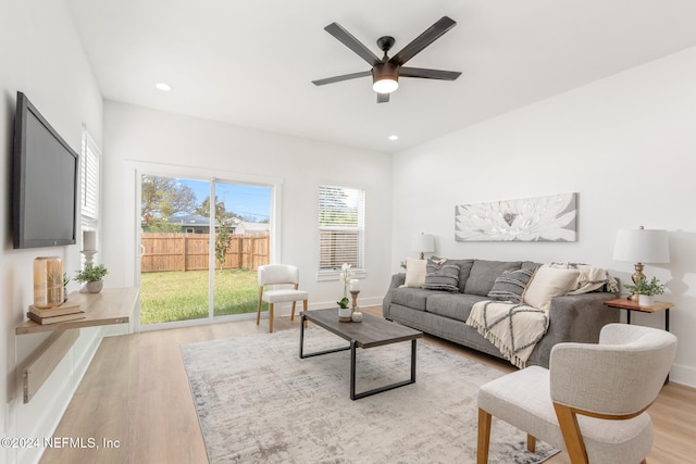 living room with ceiling fan and light hardwood / wood-style floors