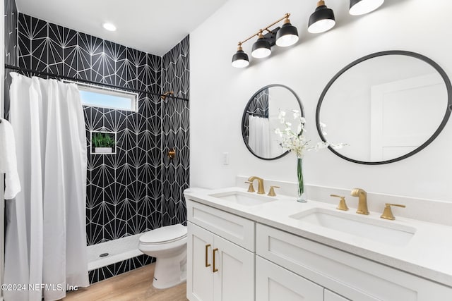 bathroom featuring a shower with curtain, hardwood / wood-style flooring, vanity, and toilet