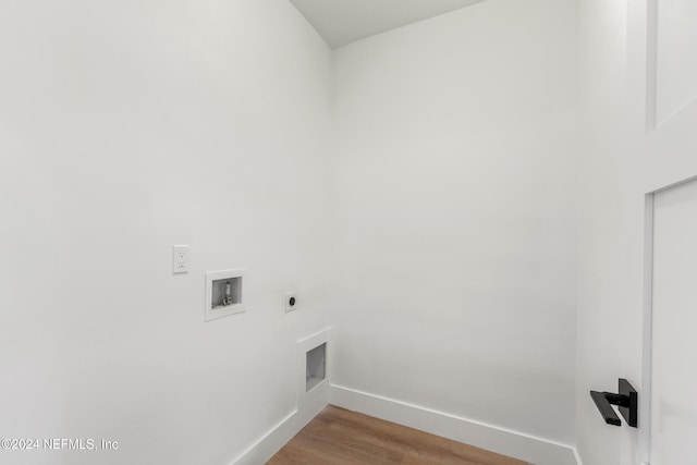 clothes washing area featuring hookup for a washing machine, hookup for an electric dryer, and light hardwood / wood-style flooring