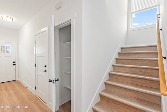 stairs with hardwood / wood-style flooring