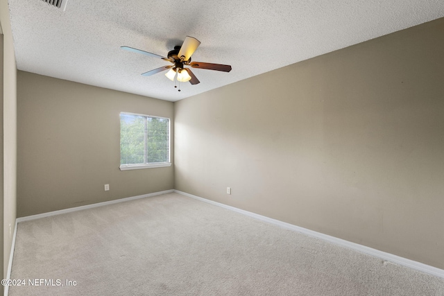 carpeted empty room with a textured ceiling and ceiling fan