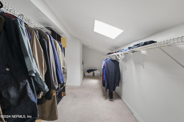 walk in closet with lofted ceiling and carpet floors