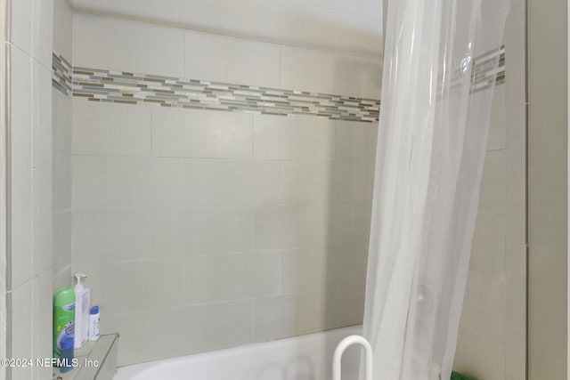 bathroom with shower / bathtub combination with curtain