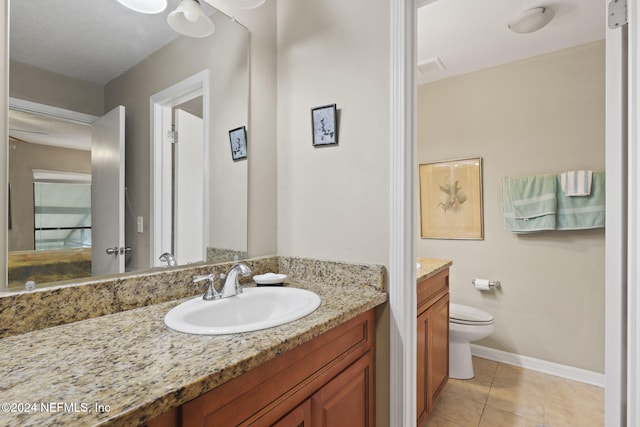 bathroom with vanity, tile patterned floors, a textured ceiling, and toilet