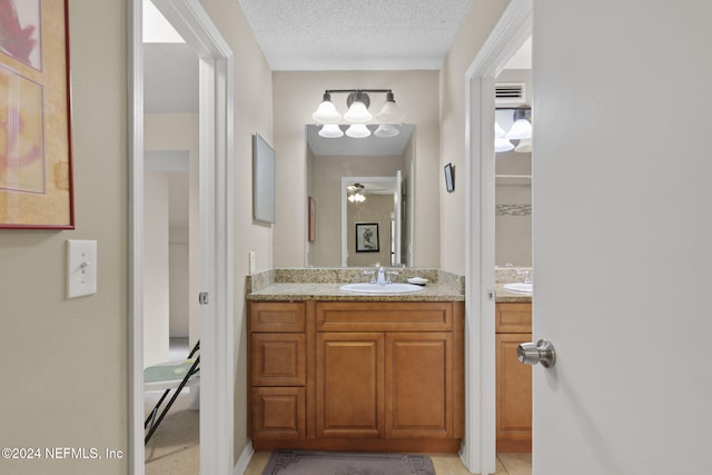 bathroom featuring vanity and a textured ceiling