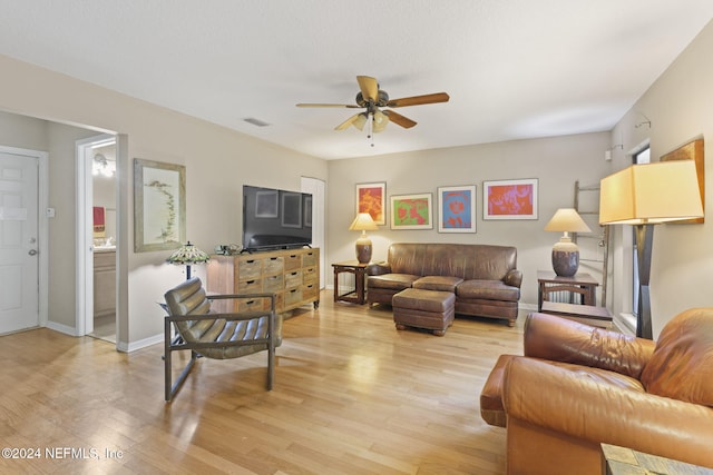 living room with ceiling fan and light hardwood / wood-style floors